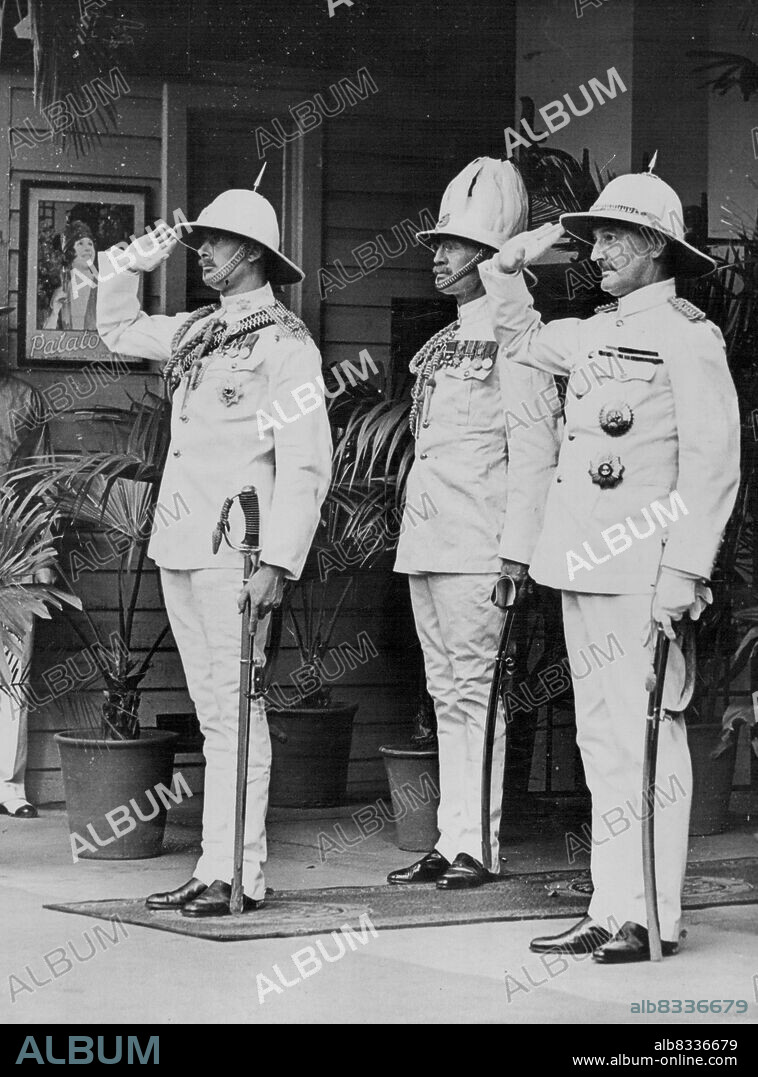 In Tropical Uniform -- His Royal Highness the Duke, the Governor (Sir Leslie Wilson) and the Duke's Chief of Staff at the salute during the playing of the National Anthem as they emergedfrom the Royal train at Brisbane. December 10, 1934.