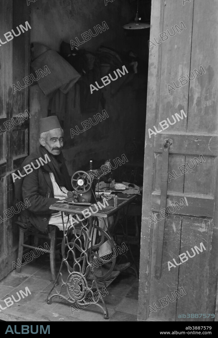 April 1943 - Tripoli, Libya. A native craftsman at his sewing machine.