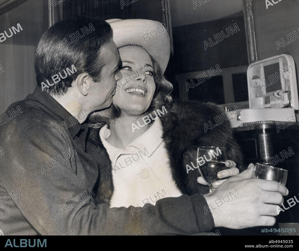 Mar 25, 1964 - Surrey, England, United Kingdom - SEAN CONNERY (L) give a kiss to co-star HONOR BLACKMAN during a break in filming the thriller ''Goldfinger'' at Pinewood Studios. (Credit Image: © Keystone Press Agency/Keystone USA via ZUMAPRESS.com).