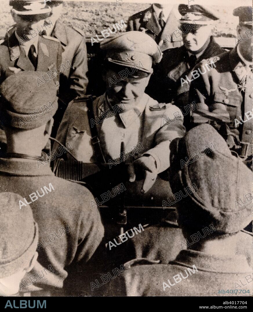 Luftwaffe commander Hermann Göring visiting a flak battery, Berlin, World War II, 1943. A decorated World War I fighter ace who flew with Baron Manfred von Richthofen's squadron, Göring (1893-1946) (right) joined the Nazi party in 1922. The following year he was involved in the Munich Beer Hall Putsch alongside Adolf Hitler. After the Nazis came to power in 1933, Göring became one of the new regime's leading figures. He commanded the Gestapo until 1934, when he handed its command over to Heinrich Himmler, and from 1935 onwards was commander of the Luftwaffe, the German air force. In the face of increasingly heavy Allied bombing of Germany's cities as the Second World War progressed, Göring's boasts of the capabilities of the Luftwaffe were listened to with increasing cynicism by the civilian population.