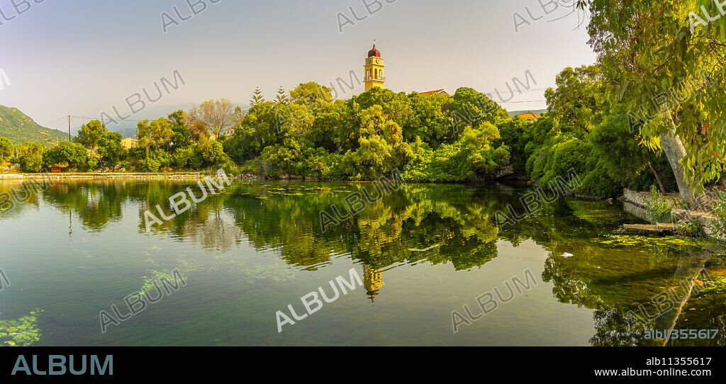 View of church reflecting in Karavomilos Lake in Sami, Sami, Kefalonia, Ionian Islands, Greek Islands, Greece, Europe.