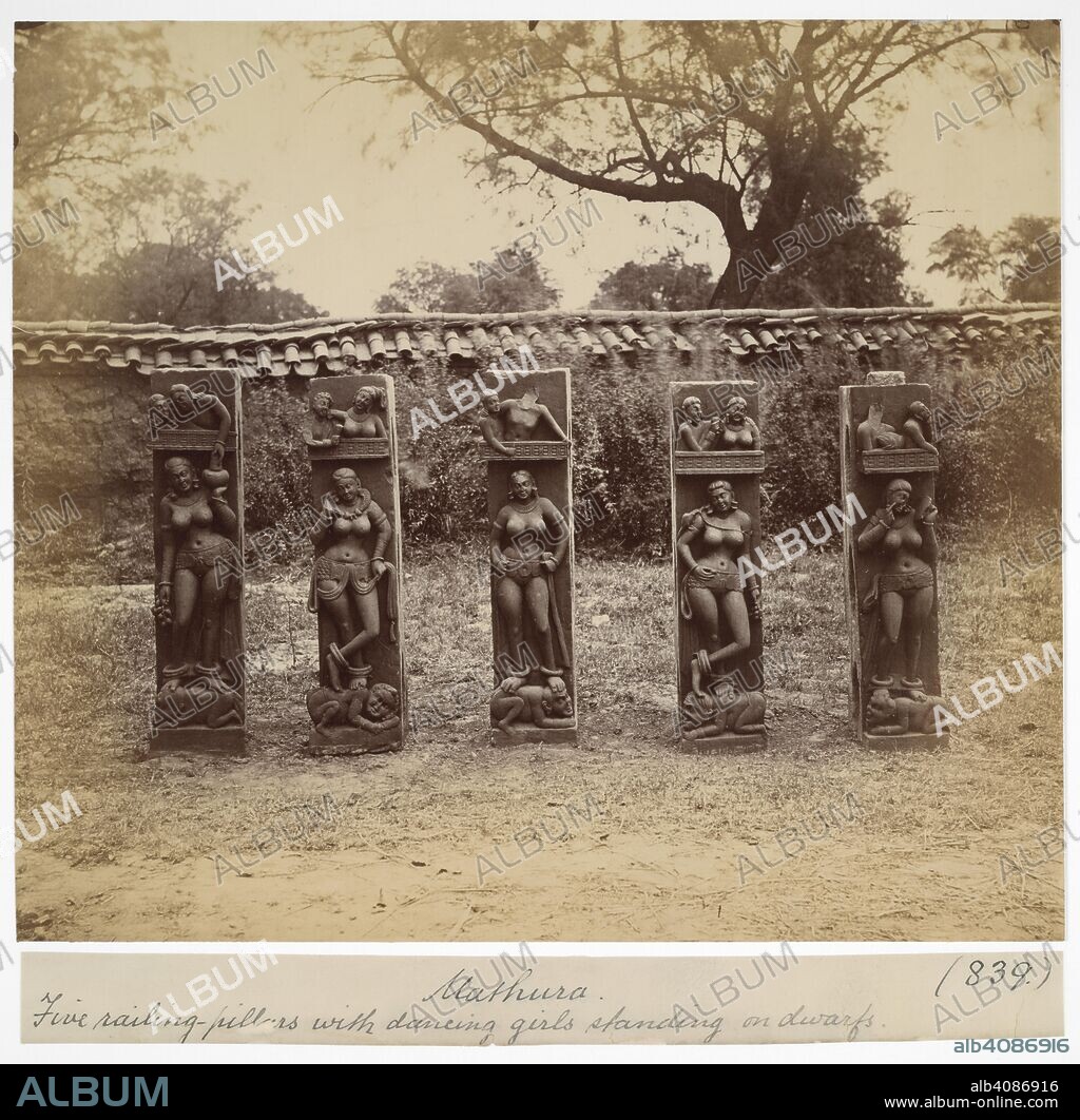 Five railing pillars, with dancing girls standing on dwarves Mathura. A photograph of the five pillars, finely carved in deep relief, standing side by side in a garden. Archaeological Survey of India Collections: Indian Museum Series (Duplicates). c. 1872. Photograph. Source: Photo 1003/(839). Language: English.