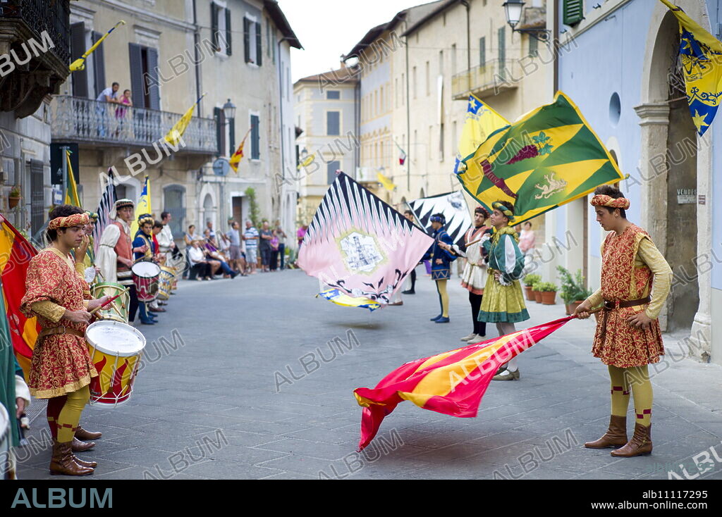 Contrada young man in livery costumes at traditional parade in Asciano, inTuscany, Italy.