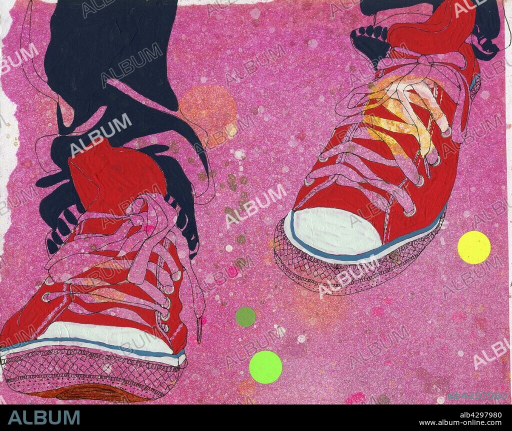 Feet wearing pair of red canvas shoes.