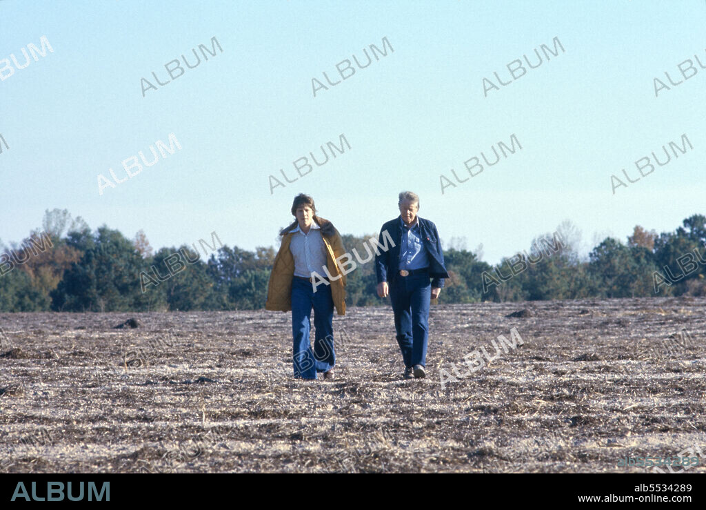 U.S. President Jimmy Carter with his son James Earl "Chip" Carter III, full-length portrait walking through Field, Plains Georgia, USA, Bernard Gotfryd, 1977.