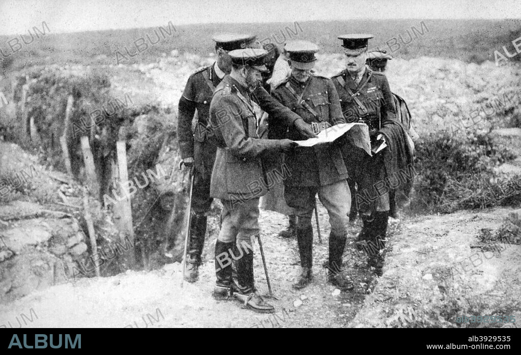 King George V (1865-1936) (1936) with General Sir Henry Seymour Rawlinson and General Congreve at St George's Hill, near Fricourt, 10th August 1916. Fricourt is a little village about five kilometres from Albert, in the northern French département of the Somme. It was close to the front line for much of World War I and saw particularly fierce fighting during the Battles of the Somme and the Battles of Albert. George, the second son of Edward VII and Alexandra of Denmark, was born at Marlborough House on 3rd June, 1865. In 1893 he married Princess Mary (with whom he had six children) and in 1910, upon the death of his father, he became king. In 1924 he appointed Ramsay MacDonald, Britain's first Labour Prime Minister, and in 1932 he introduced the idea of broadcasting a Christmas message to the people. He died of influenza on 20th January, 1936 and was succeeded by his eldest son, Edward. From His Majesty the King, 1910-1935, introduction by HW Wilson (Associated Newspapers Ltd, London, 1936).