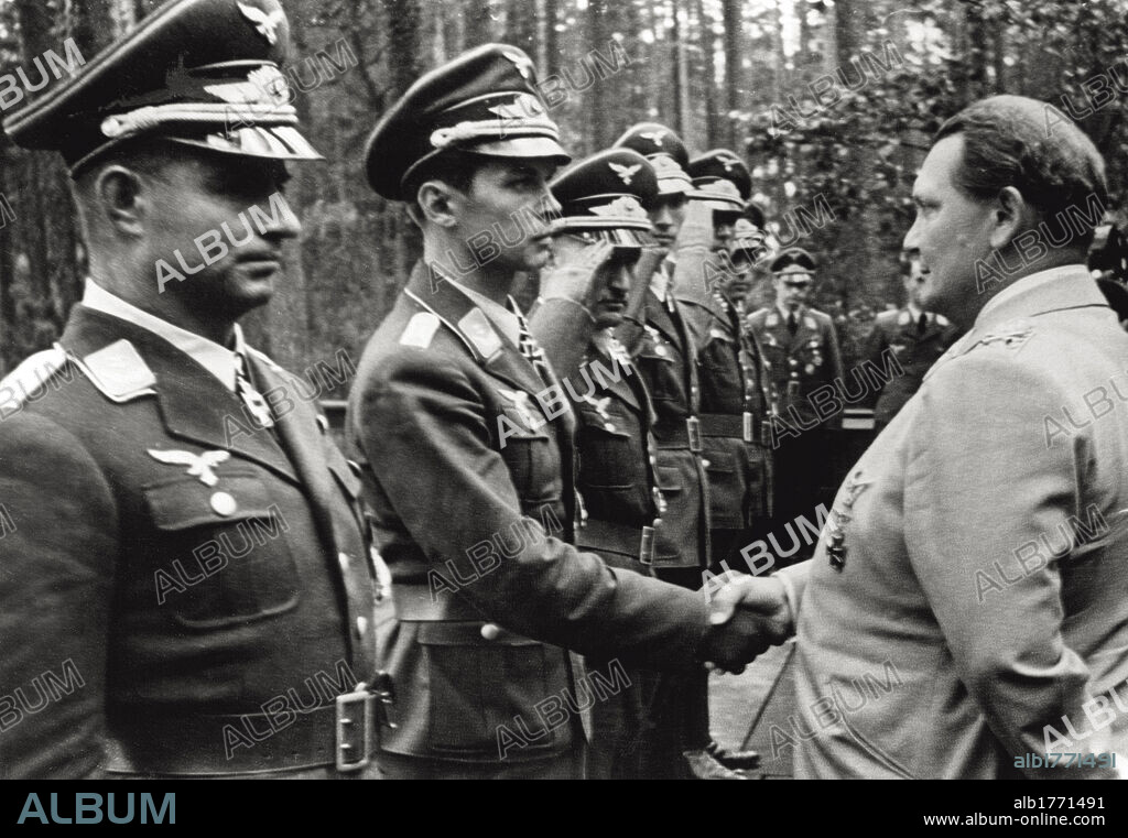 Hermann Goering shakes hands with an officer. The German Ministry of Aviation Hermann Goering, is passing in review some officers of the Luftwaffe. He is now photographed while he is shaking hands with a quite young officer. Germany, 1941.