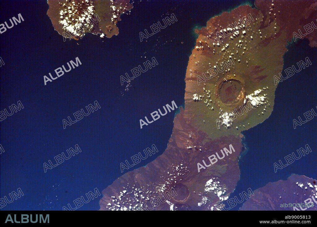 This image of the Galapagos Islands captures two large shield volcanoes on Isla Isabella, The northern volcano is Darwin and the southern, Alcedo. Isla Fernandina and Isla San Salvador are just visible on either side of Isla Isabella.