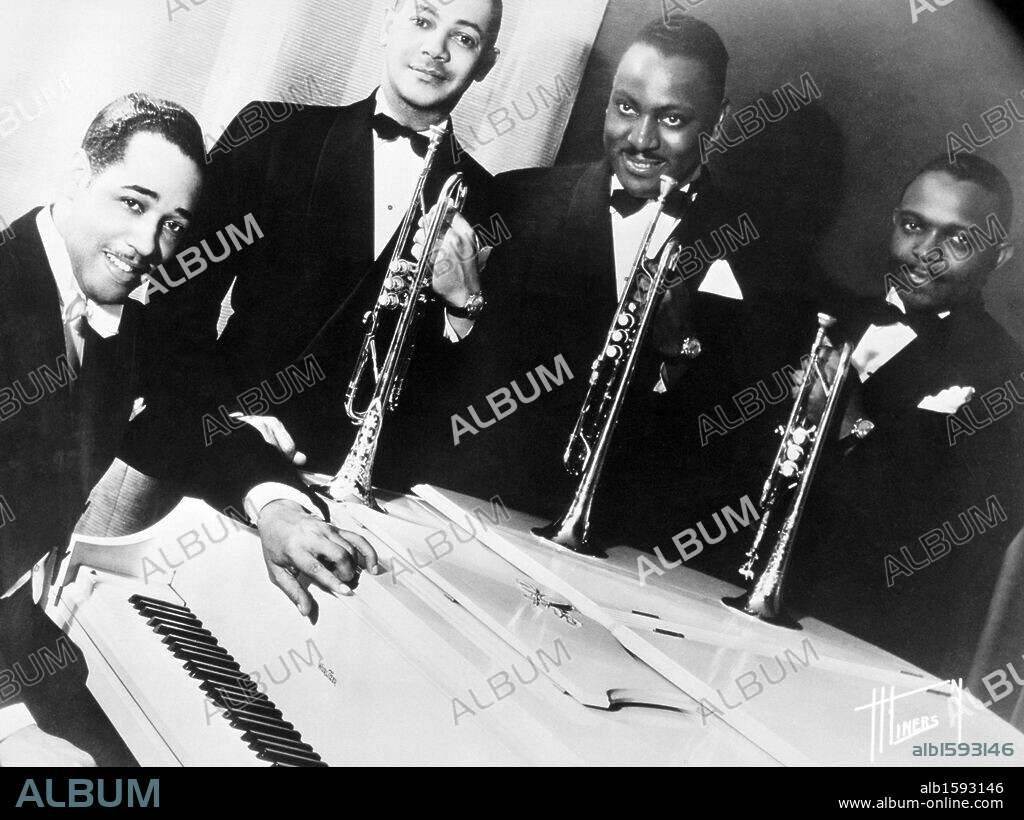 Portrait of American jazz musician Duke Ellington at a white piano with three of his horn players (L-R): Artie Whetsol, Cootie Williams and Rex Stewart. 1940.