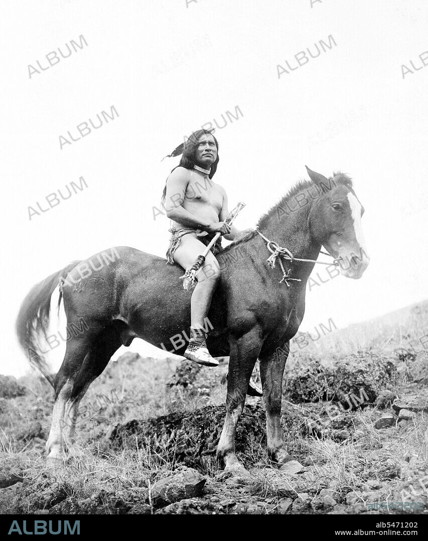 Edward S. Curits Native American Indians - Nez Percé man, wearing loin cloth and moccasins, on horseback circa 1910.