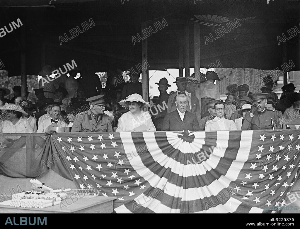 Woodrow Wilson On Reviewing Stand, 1917 or 1918. Josephus Daniels, Major General Hugh Lenox Scott, Edith Wilson, President Woodrow Wilson,  Secretary of War Newton Diehl Baker. Note certificates on table in foreground.