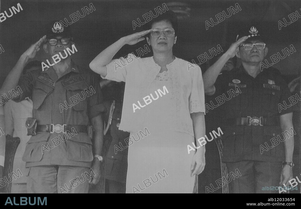 Philippine President Corazon Aquino, Armed Forces Chief of Staff General Fidel Ramos, and 5th Infantry Battalion Commander Brig. Gen. Felix Brawner Jr., salute at the honour guard during the President's first visit at the army camp since she took office. December 1986.