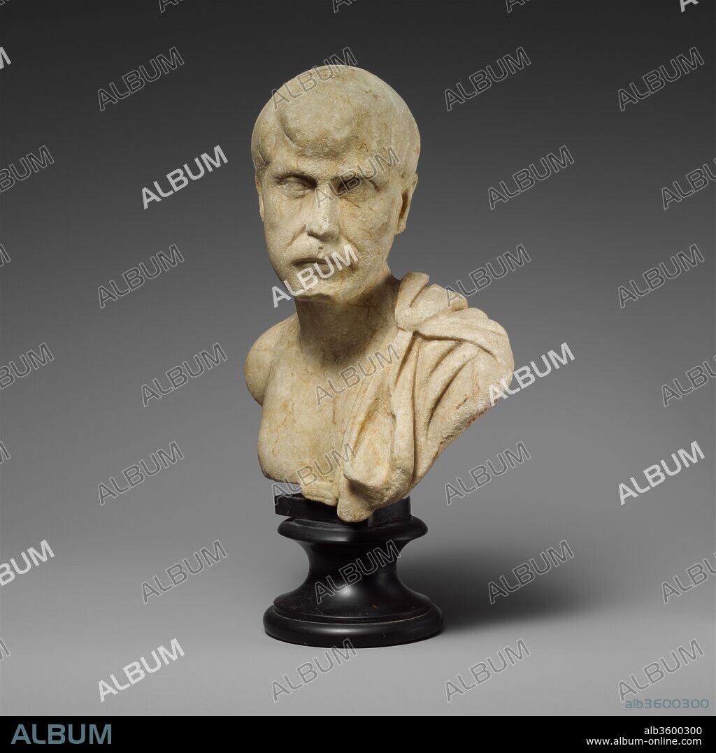 Marble bust of a man. Culture: Roman. Dimensions: H. 7 3/4 in. (19.7 cm).  Date: 3rd century A.D.. Beardless man with cloak on left shoulder. The  barely articulated hairst - Album alb3600300