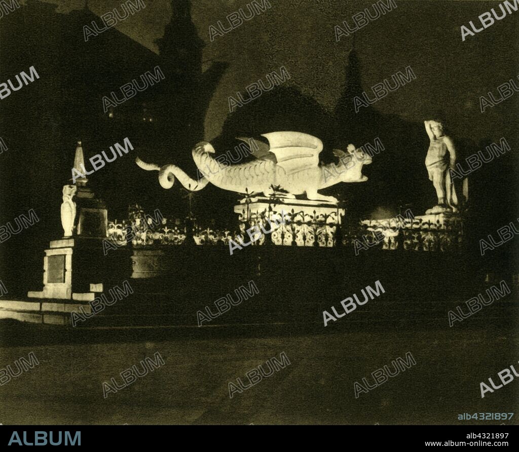 The Lindwurm Fountain, Klagenfurt, Austria, c1935. Sculpture of a dragon in the town of Klagenfurt am Wörthersee in the state of Carinthia. The skull of an Ice Age woolly rhinoceros was found in a nearby quarry in the 14th century, and was mistaken for that of a dragon. A myth grew up in which a hero slayed a dragon, and the statue was built in the 16th century to comemmorate the story. The fountain and sculpture of Hercules were added later. From "Österreich - Land Und Volk", (Austria, Land and People). [R. Lechner (Wilhelm Müller), Vienna, c1935].