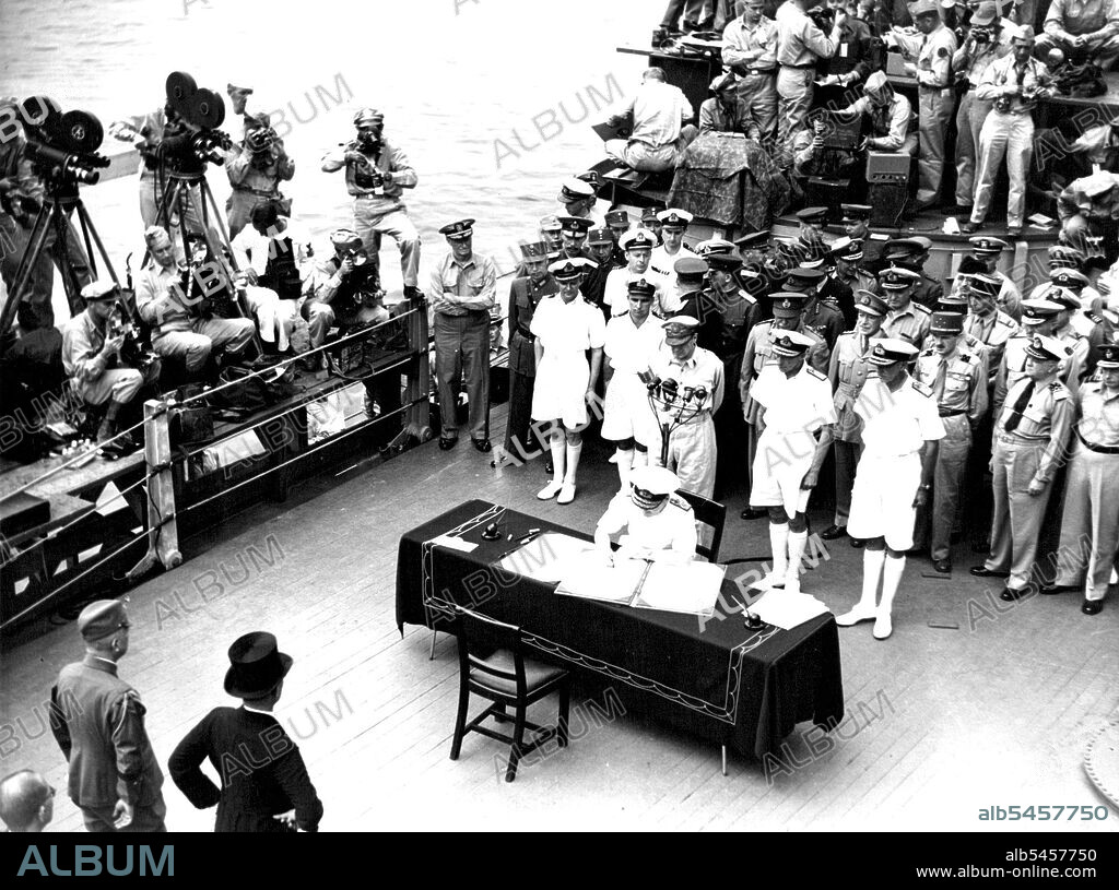 Surrender In Tokyo Bay -- Admiral ***** Bruce Fraser with line up Allied Nations Signatories behind him and signs the surrender document on behalf of the United Kingdom. The ceremony took place on board Admiral Chester Nimitz's Flagship, U.S.S. Missouri in Tokyo Bay. September 10, 1945. (Photo by Australian Official Photo).