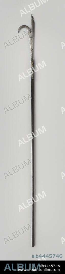 A peak with scythe-shaped hook, Peak with iron scythe-shaped hook on a dark brown wooden shaft. The blade is double edged and splits in the middle. One half runs in a point with a cutting edge running inwards into a point. The other half bends over and therefore has the shape of a scythe. Before the split point an engraved inscription of a wheel with five spokes and a sign consisting of a semicircular circle with two continuous lines. The blade is attached to the shaft with two springs with two rivets on each side. The shaft is painted black and has no foot, Europe, anonymous, c. 1599 - c. 1799, kling, nagels, schacht, l 240.5 cm l 52 cm Ã— w 17 cm l 188.5 cm.