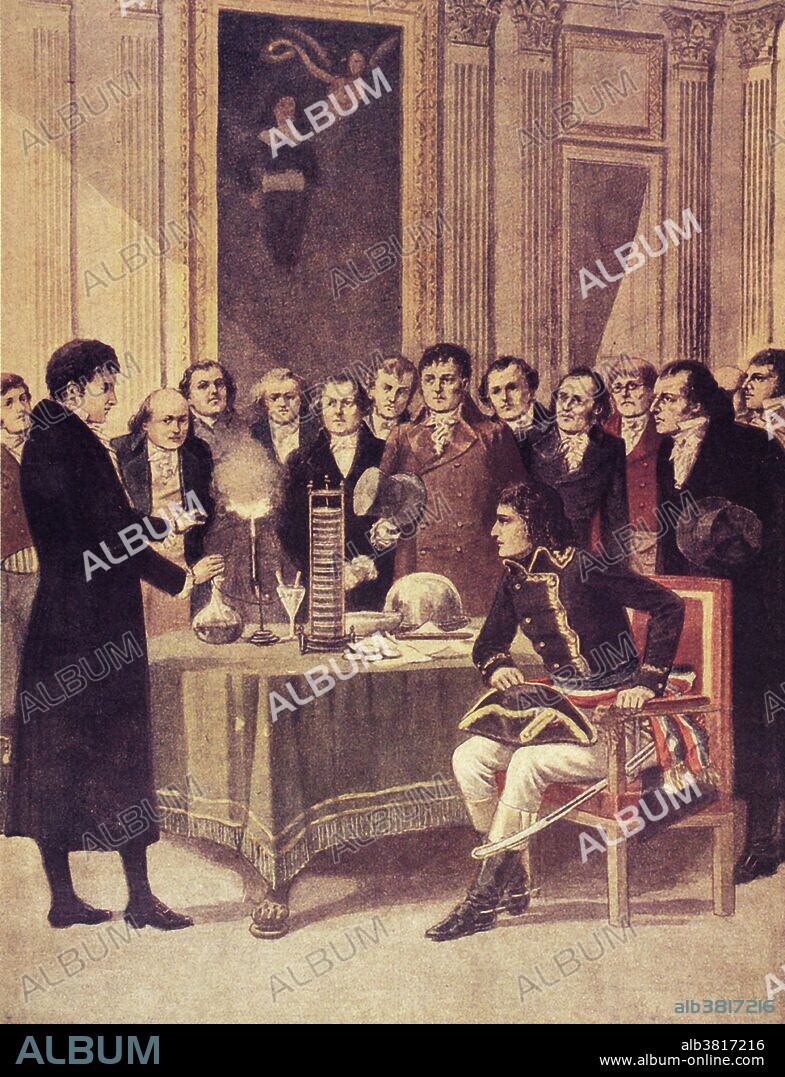 Count Volta demonstrates his newly-invented battery or "Voltaic pile" to Napoleon. Alessandro Volta (1745- 1827) was an Italian physicist. He became interested in electricity in 1786 after seeing the work of Galvani. Volta was the first to show that an electrical current flowed when two dissimilar metals were brought into contact. In 1800 he constructed a device which used this effect to produce a large flow of electricity. Bowls of salt solution were connected together by metal strips, each composed of copper at one end & tin or zinc at the other, and a current was produced. A compact version of this, using a stack of discs of copper, zinc & cardboard moistened with salt solution, was shown to Napolean in 1801. Upon presenting his invention, Napolean awarded Volta the medal of the Legion of Honor and made Volta a count. The unit of electrical potential, the volt (V), is named after him.