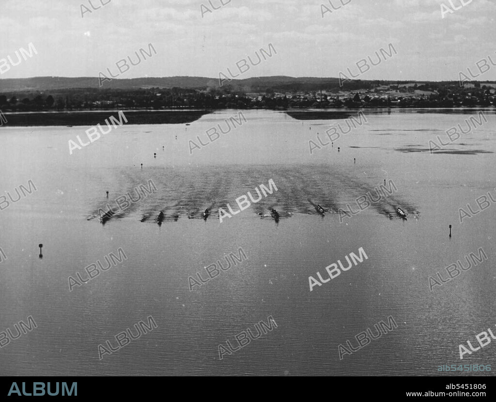 Olympic Rowing Course at Lake Wendouree: Lake Wendouree, Ballarat, Victoria, the venue for the rowing and canoeing events at the 1956 Olympic Games. Seventy four miles northwest of Melbourne, 588acre Lake Wendouree provides a suitable expanse of calm water for the events. Ample breadth is provided throughout the Olympic course for six eightoar crews to race abreast. Wendouree has accommodated as many as 20 eights abreast in one race. Three local rowing clubs and a sailing club have headquarters on its shores, which are surrounded by 80 acres of parkland and shady trees. December 15, 1955. (Photo by Australian Official Photograph).