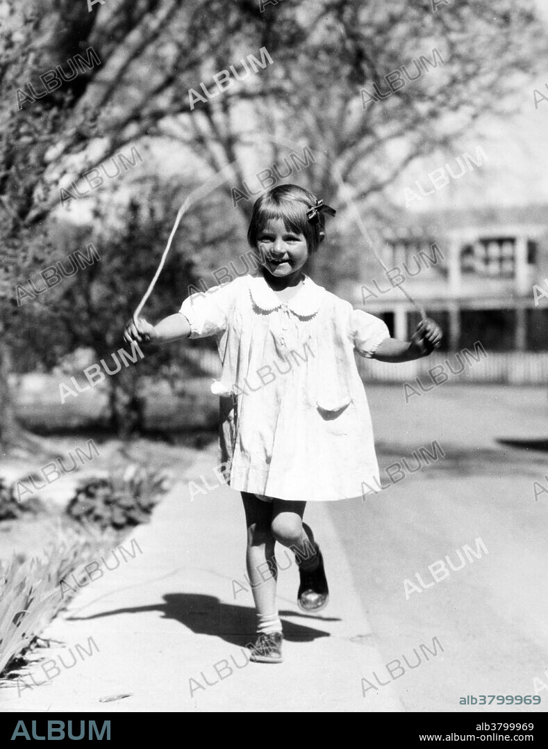 Entitled: "Girl jumping rope." Skipping rope or jumping rope s the primary tool used in the game of skipping played by children and many young adults, where one or more participants jump over a rope swung so that it passes under their feet and over their heads. This may consist of one participant turning and jumping the rope, or a minimum of three participants taking turns, two of whom turn the rope while the third participant attempts to jump into the turning rope. The game begins when the skipper jumps in and ends when the skipper messes up. The first concrete evidence of jump rope activity can be seen in medieval paintings where children roll hoops and jump rope down the cobblestone streets of Europe. Photographed for the Farm Security Administration by H. Armstrong Roberts, May 1936.