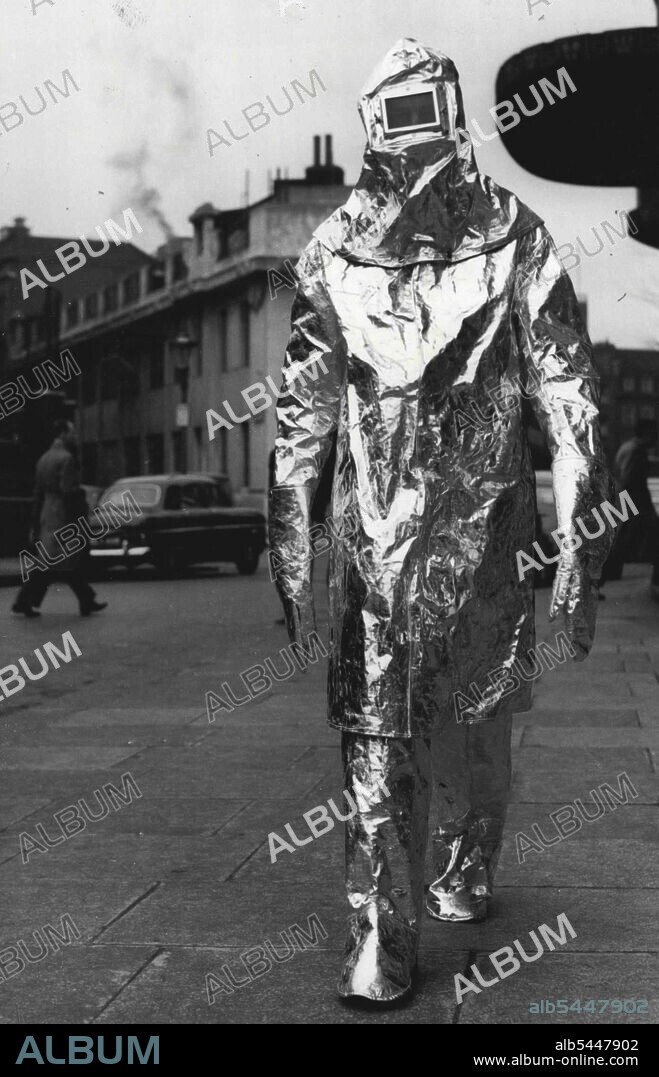 "Aluminum Man Arrives" -- Mr. W. G. Wood is seen arriving at the Horticultural Hall, Westminster, today in an aluminum foil suit designed as the latest heat protection clothing. The "Aluminum Man" was at the second National Factory Equipment Exhibition that opened at the Horticultural Hall and runs until 26th March. March 22, 1954. (Photo by United Press Photo).
