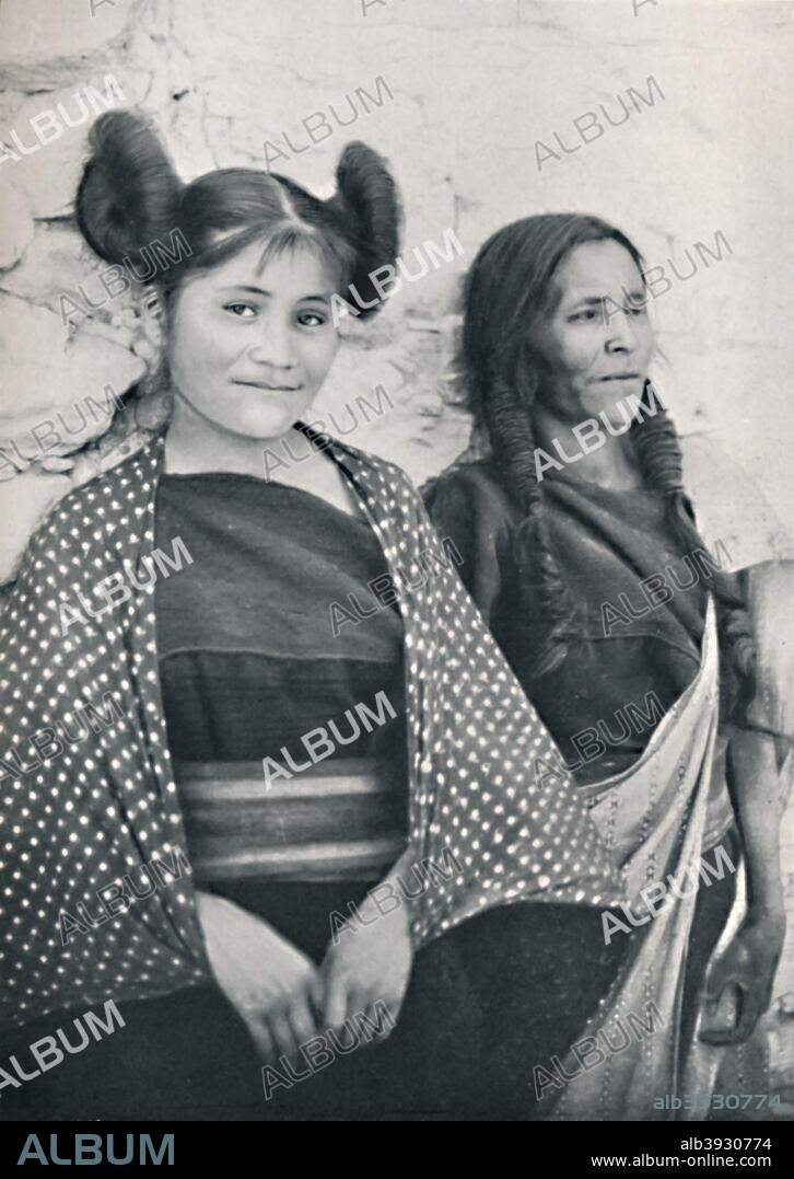An Arizona Hopi girl and her mother, 1912. The girl's hairstyle identifies her as being unmarried. From The Living Races of Mankind, Vol. II. [Hutchinson & Co, London, 1912].