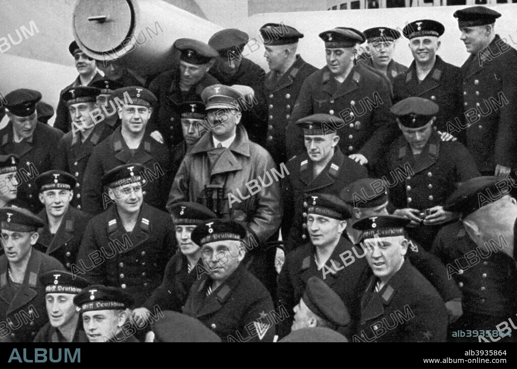 Adolf Hitler visiting a battleship, Germany, 1936. Hitler (1889-1945) posing for a photograph with the crew. A print from Adolf Hitler. Bilder aus dem Leben des Führers, Hamburg: Cigaretten/Bilderdienst Hamburg/Bahrenfeld, 1936.