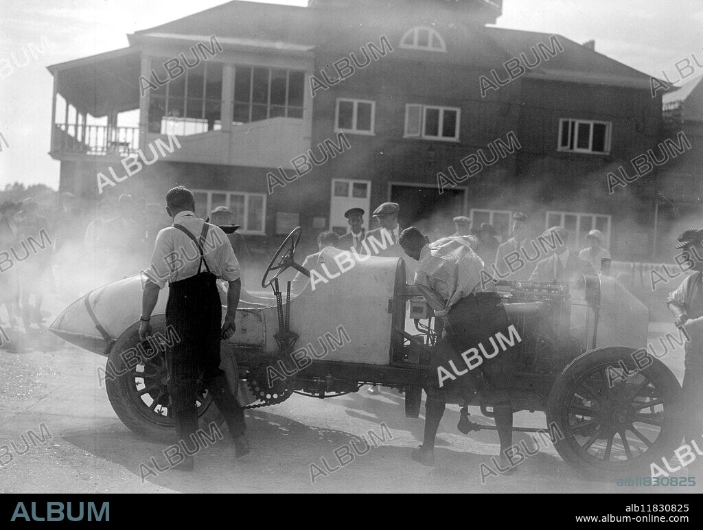 "Hot Stuff" At Brooklands . Major Cooper's 400 h.p. " Fiat ", fornidably named " Mephistopheles " is expected to do great things at Brooklands on Whitsun Monday, Our picture, taken on Saturday shows the monster literally seething with energy. 14 August 1921.