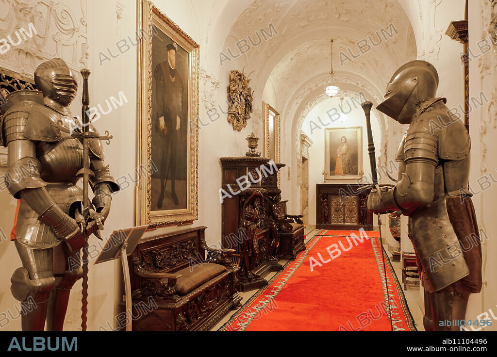 Sinaia, Romania Peles Castle interior decoration with Medieval steel knights' armour on a corridor with paintings.