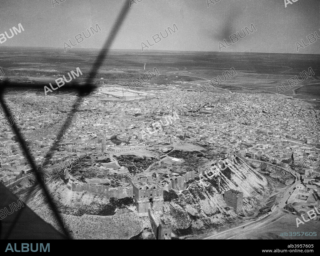 Citadel of Aleppo, Syria, 1931. One of the most historic cities in the world, Aleppo (ancient name: Halab) is strategically placed on all the major thoroughfares through North Syria. In 1986 Aleppo was designated as a UNESCO World Heritage Site. The city was devastated in the Syrian Civil War.