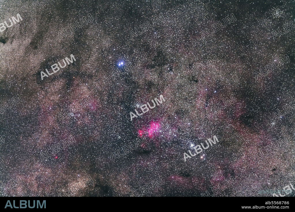 The complex region of NGC 6231 in the tail of Scorpius, with the brightest star cluster at lower right being NGC 6231 itself while the cluster at centre is NGC 6242. The nebula is IC 4628. The pair of bright stars at top are Mu 1 and 2 Scorpii. The colorful double star at bottom is Zeta 1 and 2 Scorpii. To the naked eye this area appears elongated and fuzzy, like a comet. It was mistaken for Comet Halley in 1986.