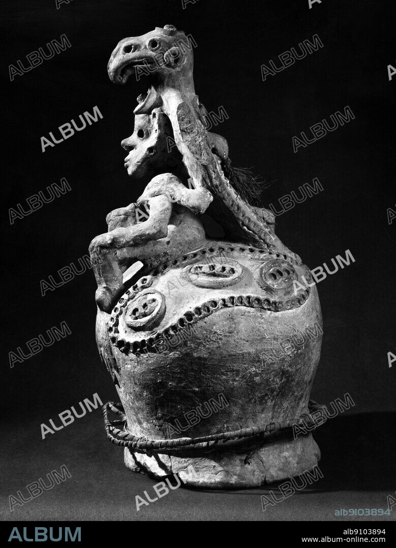 A pottery gable finial for a ceremonial house , with a female figure with a fish eagle perched on her shoulders , Yentchan village , Iatmul , Middle Sepik area , 19th Century . Height 21 inches or 53.3 cm.