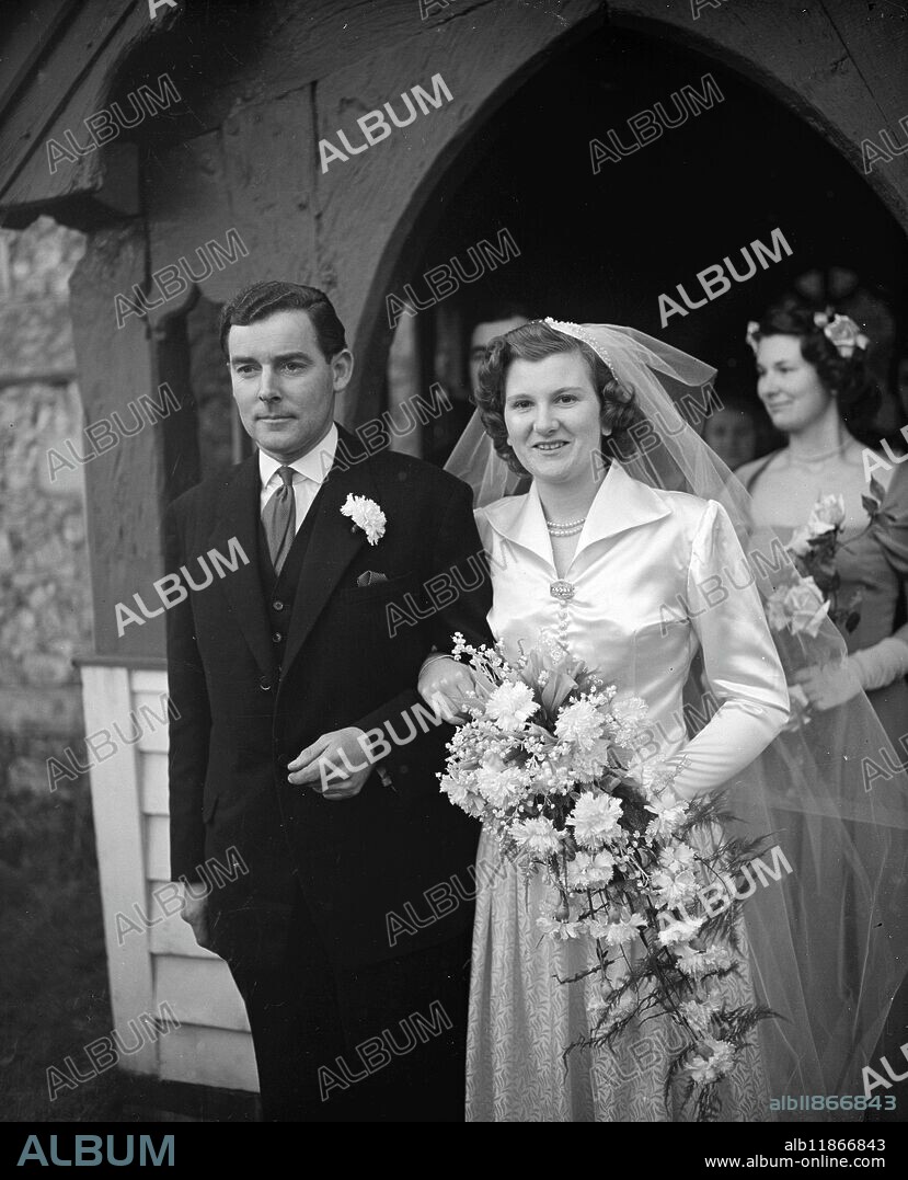MEAKER BRIDE AT VILLAGE WEDDING. Wedding of Miss Pamela Anne Meaker, 22 year old daughter of the late Mr Edgar Jesse Meaker, a founder of the chain of men's wear shops, to Mr William Soulsby Payne, 30, took place in St Mary's Church, Ramsden Bellhouse, near Billericay, Essex, where the bridegroom lives, today, Tuesday. The bride's uncle and guardian, Mr Benjamin Meaker, who started the outfitting business with his brother Edgar, was not present at the wedding and the bride was given away by her brother. The bridegroom is the son of Mr John R Payne, retired company director and amateur yachtsman, and has known his bride since they were children. Picture shows : Bride and bridegroom leaving St Mary's Church, Ramsden Bellhouse, after the wedding. 9 January 1951.