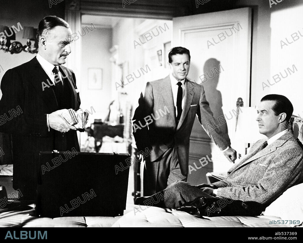 JOHN WILLIAMS, RAY MILLAND and ROBERT CUMMINGS in DIAL M FOR MURDER, 1954, directed by ALFRED HITCHCOCK. Copyright WARNER BROS.