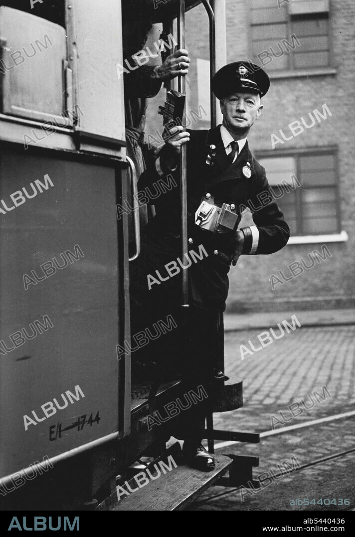 London's Oldest Conductor -- Mr. Arthur Ong setting out for a shift on his tram at Wandswoth depot. 70-year-old Mr. Artur Ong, of Wandsworth depot, who reached that age last month, is claiming to be London's oldest conductor. Everybody is surprised when Mr. Ong tells them his age - he looks far younger, and moves about his job with the energy of a man of 50. March 25, 1949. (Photo by Fox).