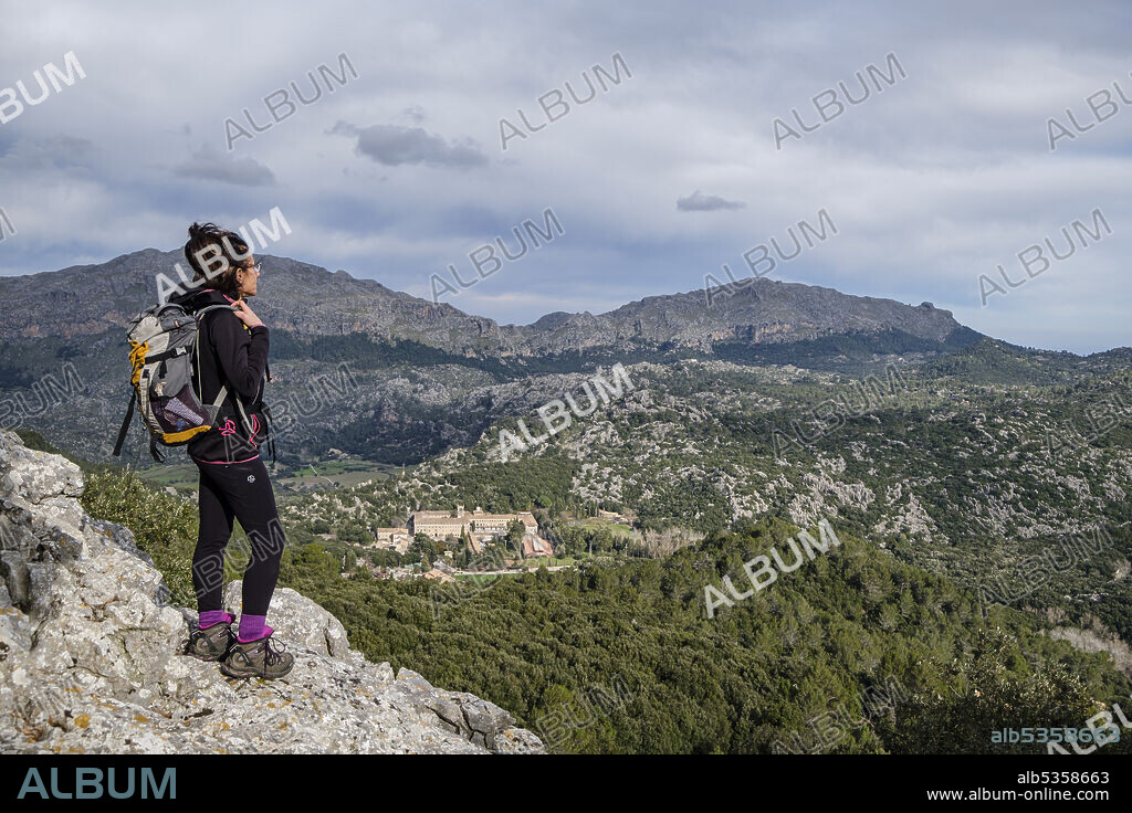 hiker observing the sanctuary of Lluc, Escorca, Mallorca, Balearic Islands, Spain.