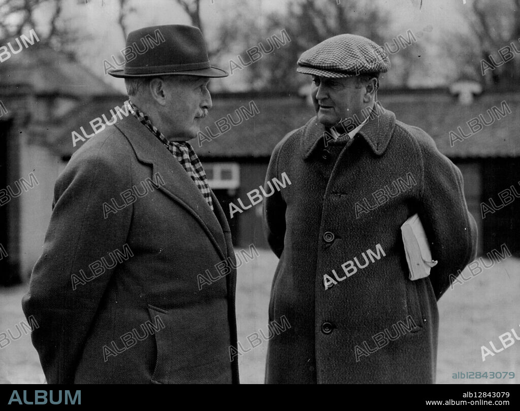 Captain Boyd Rochfort (right) the King's Trainer, talking with Captain Charles Moore, the King's racing Manager. The Queen's Trainer - Captain Boyd-Rochford gave the queen a welcome-home present. Her filly Angel Bright won the Oaks Trial Atakes almost at the moment the Queen landed in England. December 08, 1950. (Photo by Sport & General Press Agency Limited).
