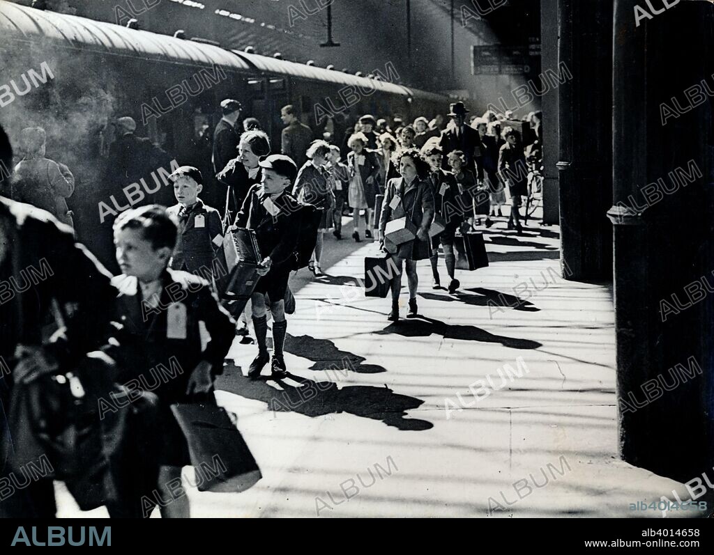 London schoolchildren being evacuated, Euston Station, World War II, 6 July 1944. In the early stages of the war, the British government ordered the evacuation of children from cities to the countryside as massive air attacks on cities were feared. Another wave of evacuations occurred in London in 1944 as it began to come under attack from V-1 flying bombs.