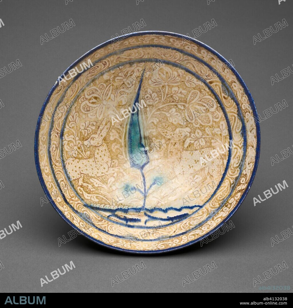 ISLAMIC. Bowl with Tree and Fish-Pond Motif. Iran; probably Kashan. Date: 1201-1400. Dimensions: 22.2 x 9.5 cm (8 3/4 x 3 3/4 in.). Fritware with in-glaze painting in blue and turquoise and overglaze painting in luster. Origin: Iran.