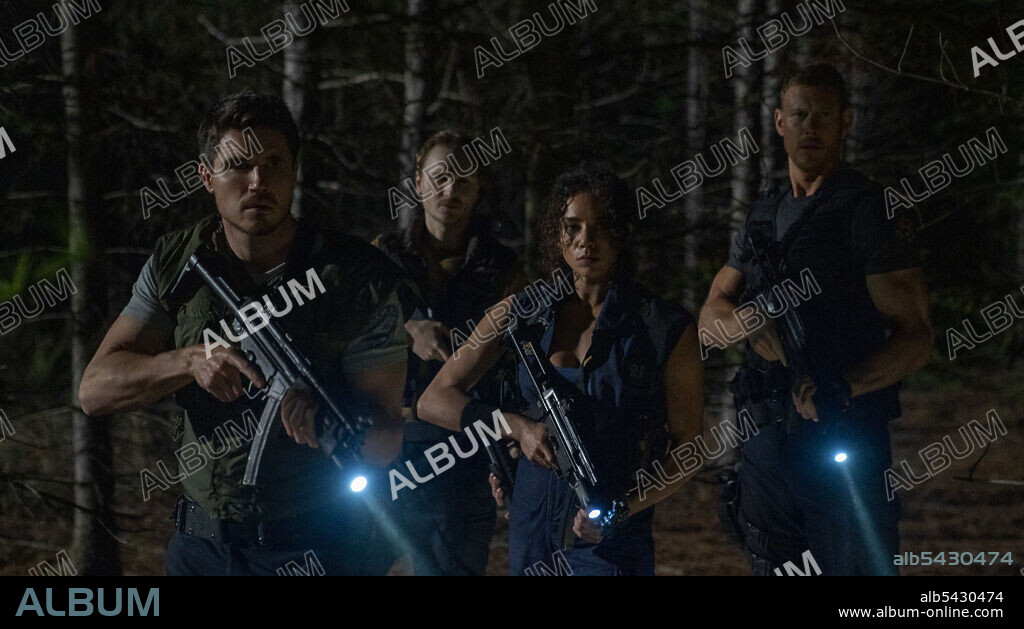 HANNAH JOHN KAMEN, ROBBIE AMELL and TOM HOPPER in RESIDENT EVIL: WELCOME TO RACCOON CITY, 2021, directed by JOHANNES ROBERTS. Copyright Constantin Film / Sony Pictures Entertainment.