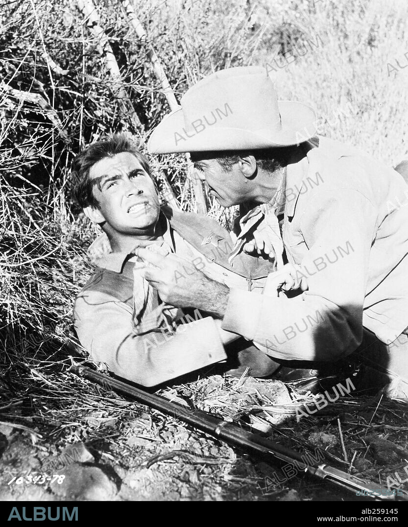 ANTHONY PERKINS and HENRY FONDA in THE TIN STAR, 1957, directed by ANTHONY MANN. Copyright PARAMOUNT PICTURES.