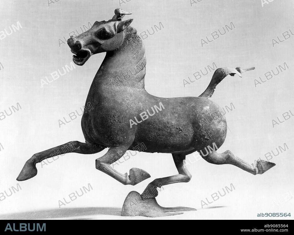 Bronze figure of a flying horse. China, VI.3 (vi) Xin to Easter Han 005202.031 -. Famous flying bronze horse and swallow from Eastern Han dynasty (206 BC to 220 AD). The original bronze piece was discovered in 1969, when villagers in the small town of Leitai, in Wuwei County, Gansu Province discovered an ancient tomb while digging foundations. Among the more than 200 relics found in the tomb, was the Flying Horse and Swallow. The horse's hoof is raised high as the startled swallow sets off the neighing, cleverly pivoting horse. In the early 1970s, replicas from Taiwan flooded the market, but that supply has been depleted. ©TopFoto.