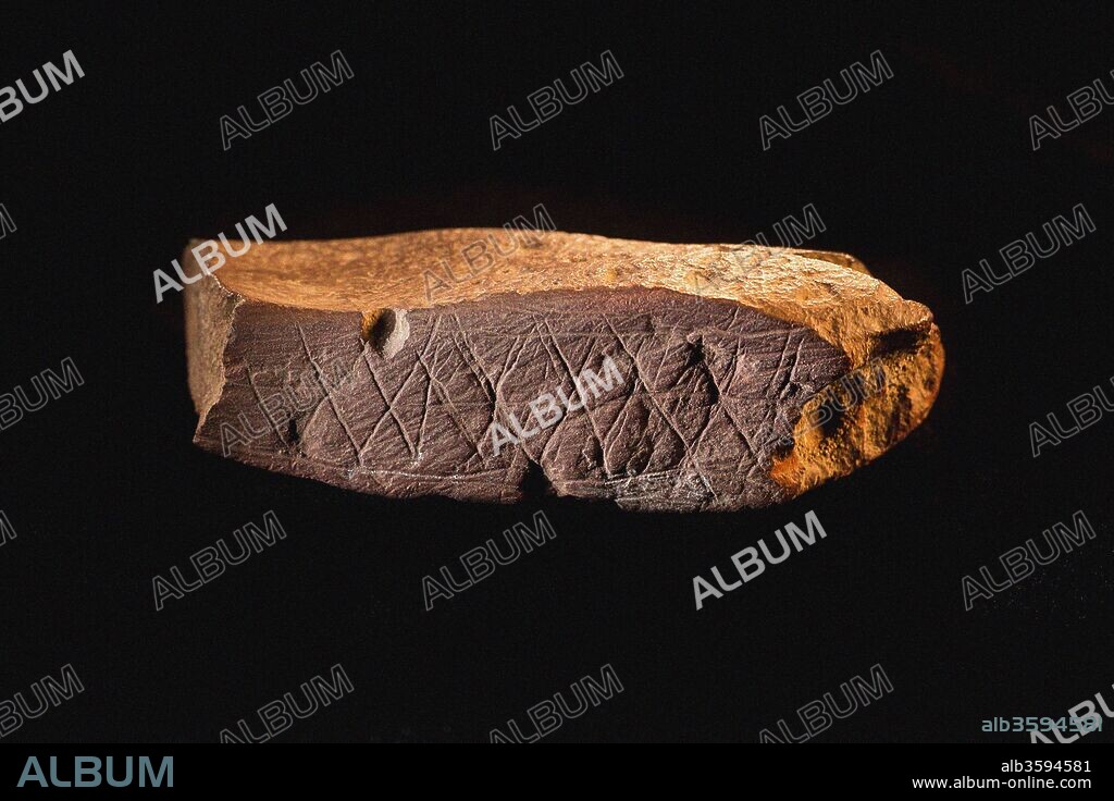 MIDDLE STONE AGE. Engraved Ocher Plaque from Blombos Cave, South Africa. The oldest artifact of mankind.