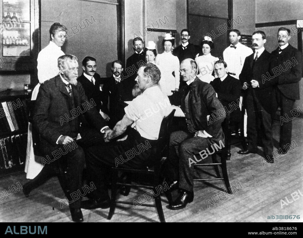 Dr. Silas Mitchell at his clinic in the Infirmary for Nervous Diseases in Philadelphia. Silas Weir Mitchell (1829-1914) was an American physician and writer.  During the Civil War he had charge of nervous injuries and maladies at Turners Lane Hospital, Philadelphia, and at the close of the war became a specialist in neurology. In this field Weir Mitchell's name became prominently associated with his introduction of the rest cure, subsequently taken up by the medical world, for nervous diseases, particularly hysteria; the treatment consisting primarily in isolation, confinement to bed, dieting and massage. His medical texts include Injuries of Nerves and Their Consequences (1872) and Fat and Blood (1877). Mitchell's disease (erythromelalgia) is named after him.
