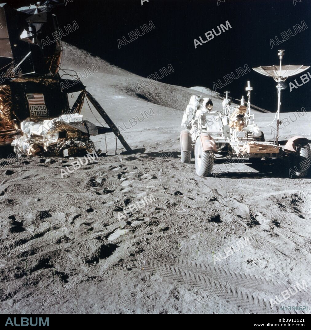 James Irwin (1930-1991) with the Lunar Roving Vehicle during Apollo 15, 1971. Irwin works on the Lunar Roving Vehicle during the first Apollo 15 lunar surface extravehicular activity (EVA-1) at the Hadley-Apennine landing site. A portion of the Lunar Module Falcon is on the left. The undeployed Laser Ranging Retro Reflector (LR-3) lies atop the LM's Modulear Equipment Stowage Assembly (MESA). Hadley Delta and the Apennine Front are in  the background to the left and St George crater is approximately 5 kilometers (about 3 miles) in the distance behind Irwin's head. Photograph taken by David R. Scott, commander of the Apollo 15 mission.