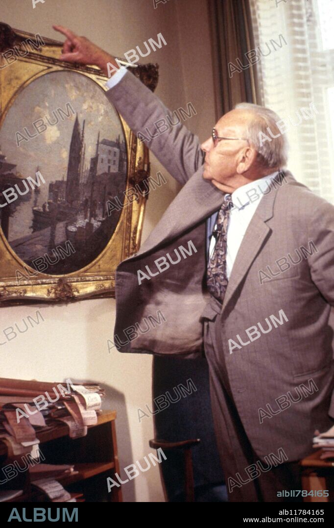 Rosenheim poltergeist, Germany, 1967: Solicitor Sigurd Adam whose office was affected. Witness Herr Brunner shows how picture rotated on the wall.