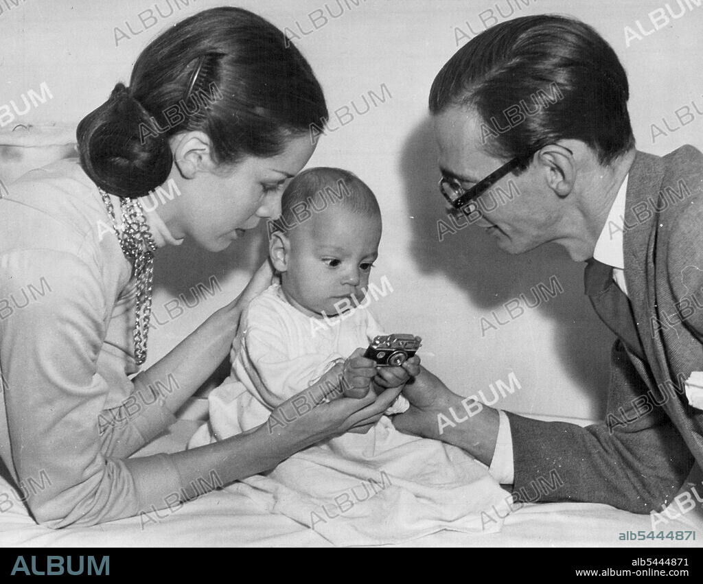 Athol Shmith, his wife "Bambi" Tuckwell and son Michael. That little camera is really a cigarette lighter. May 24, 1950.