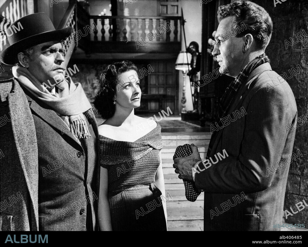 FORREST TUCKER, MARGARET LOCKWOOD and ORSON WELLES in TROUBLE IN THE GLEN, 1954. Copyright REPUBLIC PICTURES.