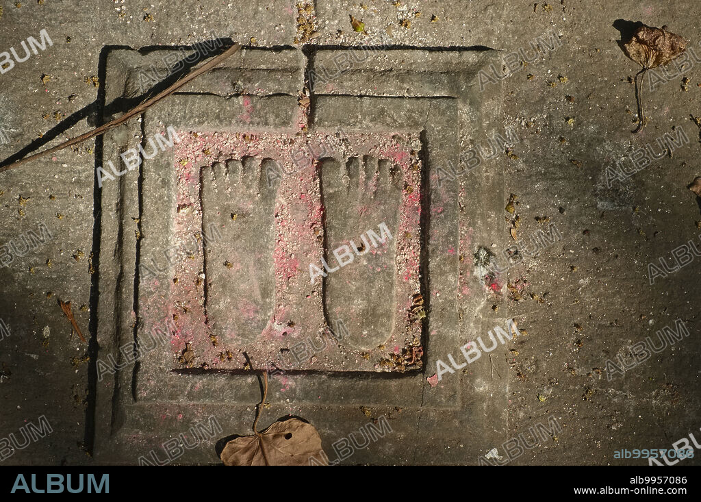 India: The symbolic footprints of Hindu god Vishnu on the grave of a saint of the Goswami sect; Walkeshwar, Mumbai. Vishnu (Sanskrit §µ§ø§ç§£Å Vi·£·áu) is the Supreme god in the Vaishnavite tradition of Hinduism. Smarta followers of Adi Shankara, among others, venerate Vishnu as one of the five primary forms of God.<br/><br/>. Hindu saints are buried instead of cremated.