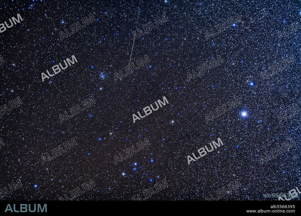 The small constellation of Canis Minor, at right, with the bright star Procyon, and Cancer the crab to the left, with the star cluster Messier 44, or the Beehive. The smaller cluster M67 is below M44. A bonus very green meteor streaks through Cancer, likely from the Geminid meteor shower. The head of Hydra is at bottom.