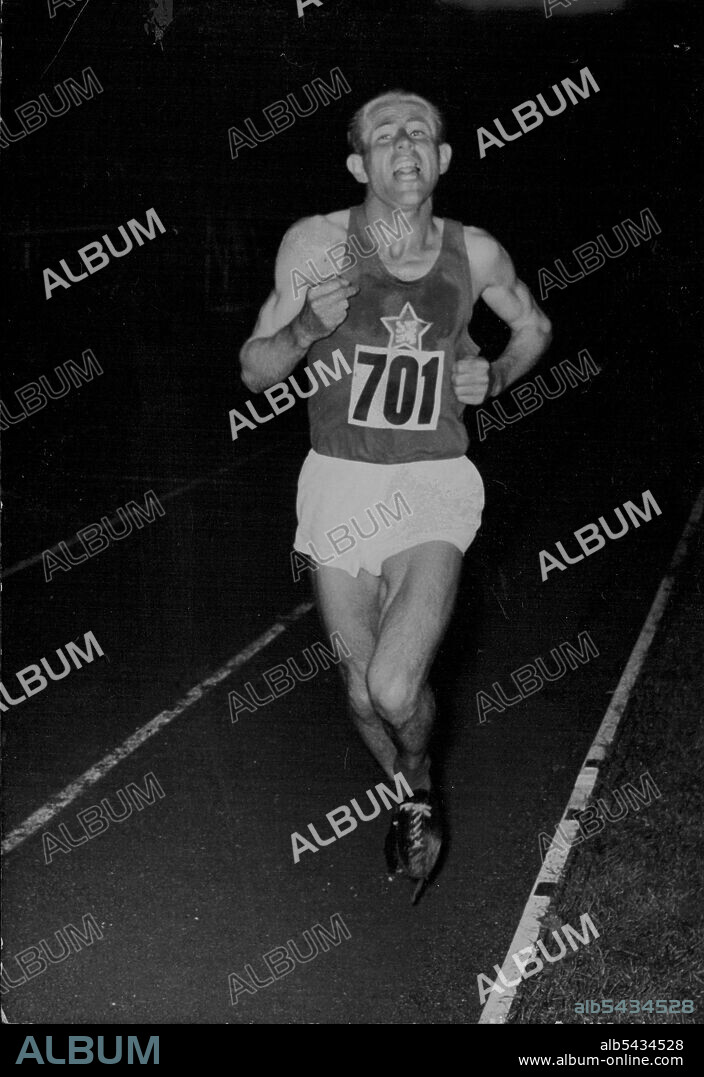 Picture of Emil Zatopek winning the 10, 000 meters at the European Games in 1954. Zatopek Leads The Way -- Zatopek burning up the track during the 10,000 metres last night... Emil Zatopek, the famous 'Bounding' Czech, won the 10,000 metres at Berne yesterday during the first day of the European Games. Kovacs of Hungary was second, with Frank Sando, of great Britain, third..... August 26, 1954. (Photo by Paul Popper Ltd.).